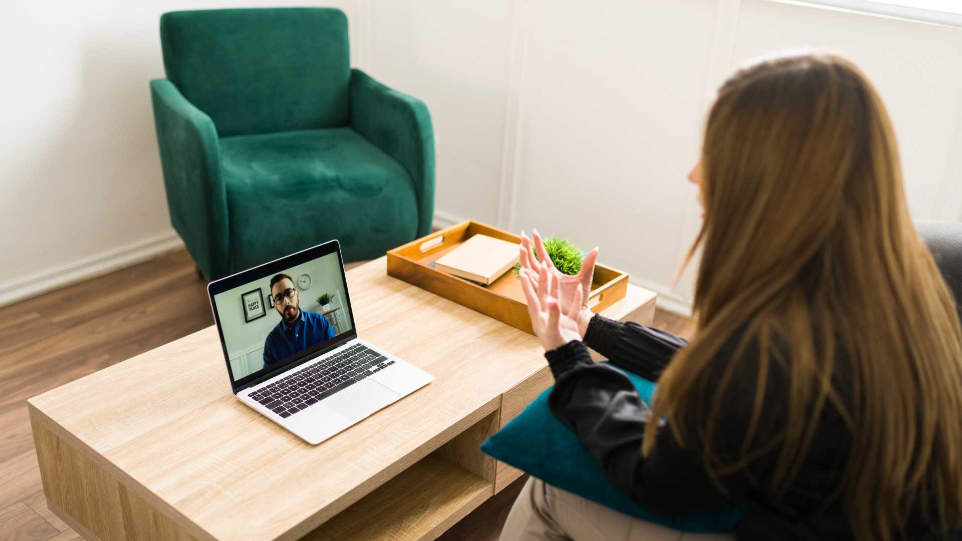 Female manager talking with director report on laptop to give effective feedback on performance.